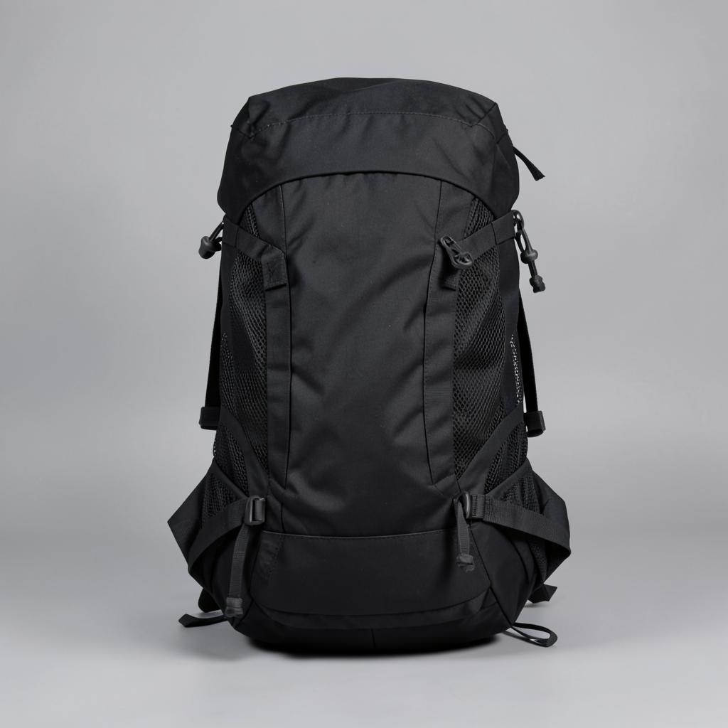 Black 28L hiking daypack with mesh back panel and trekking pole loops