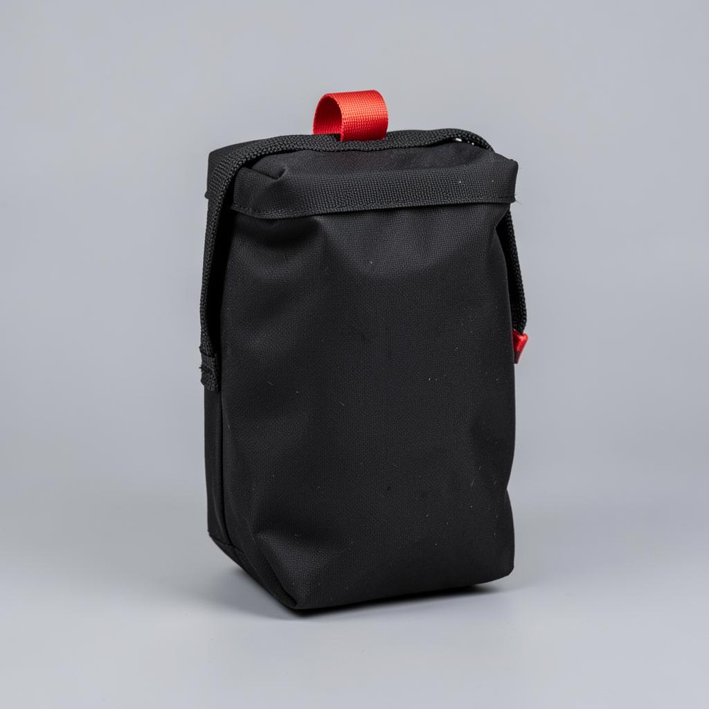 Black rip-away first aid trauma pouch with a red pull tab